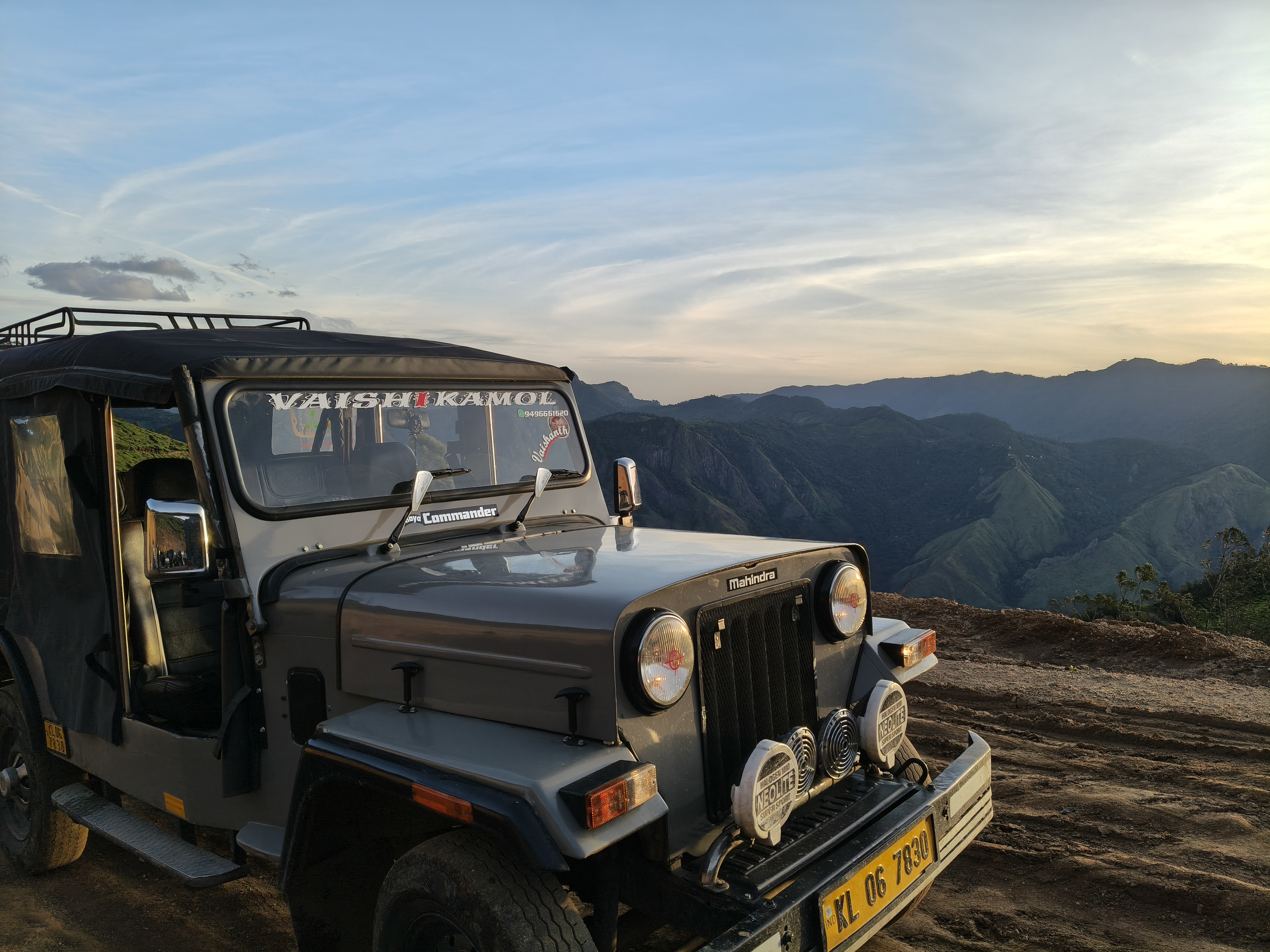 Kolukkumalai jeep safari at sunset with mountains in the background